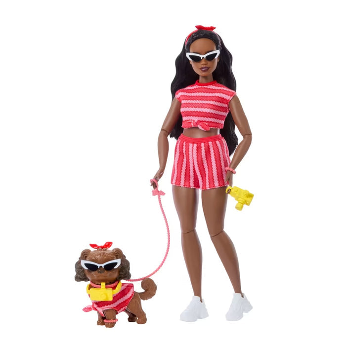 Doll in red and white outfit with dog on a white background