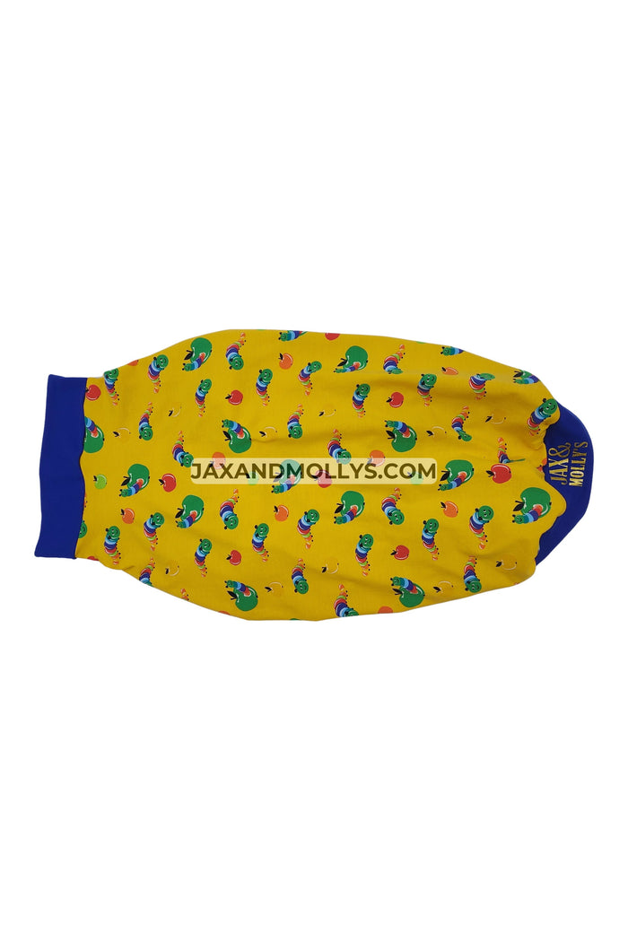 The backside of yellow dog pajama with a caterpillar print and blue trim made by Jax & Molly's