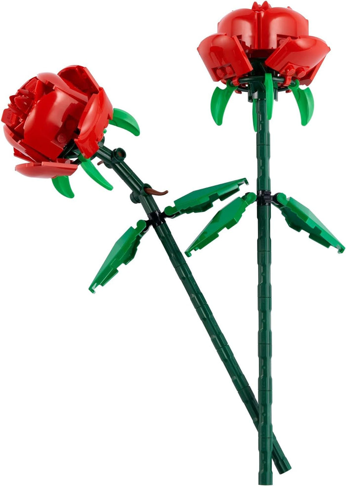 Two red roses made of interlocking bricks on a white background