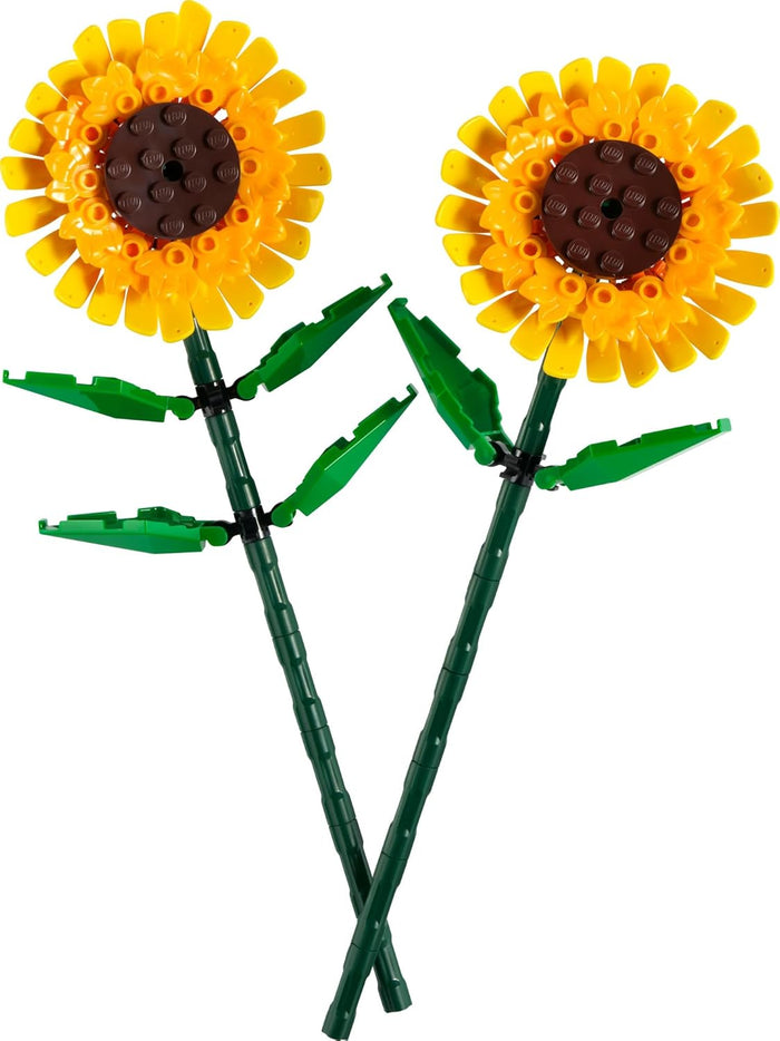 Two sunflower-shaped objects made from interlocking bricks on a white background