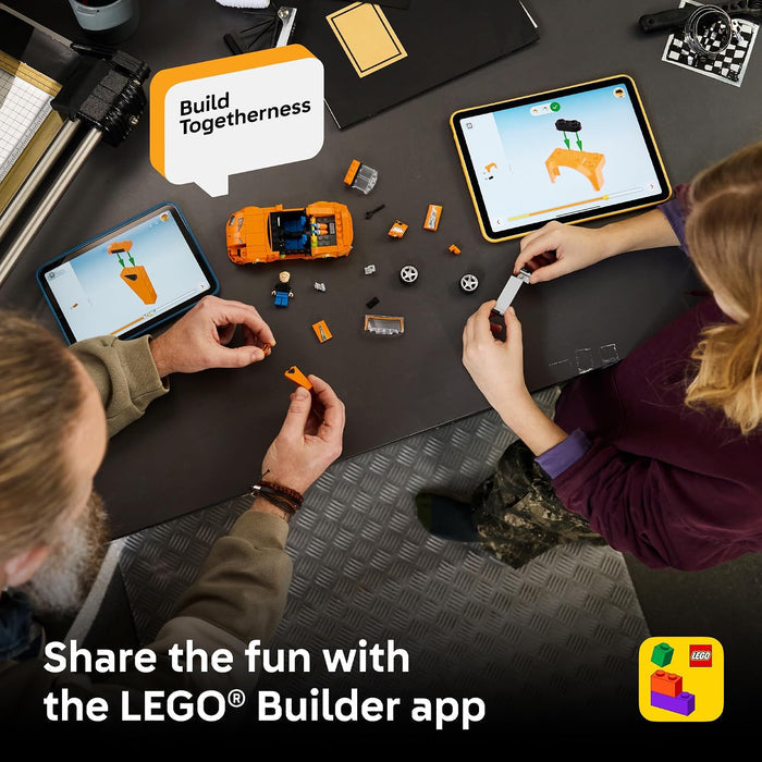 Two people building with LEGO pieces on a table, using the LEGO Builder app.