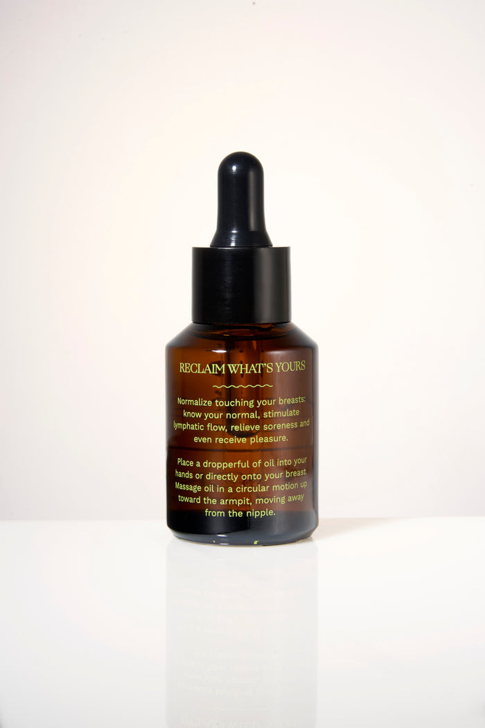 A bottle of Love Mine Breast Oil with a dropper cap