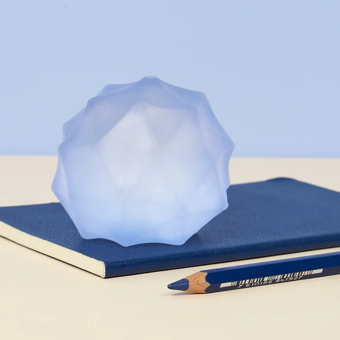 Blue Gump Burst on a blue notebook with a blue pencil against a light blue background