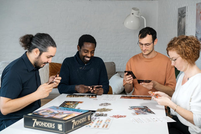 Group of adults playing 7 Wonders