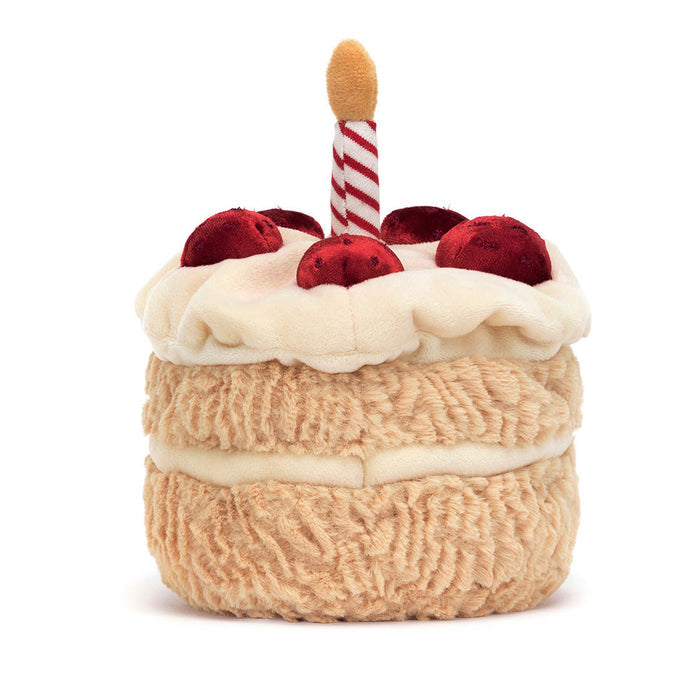 Rear view of a plush birthday cake on a white background.