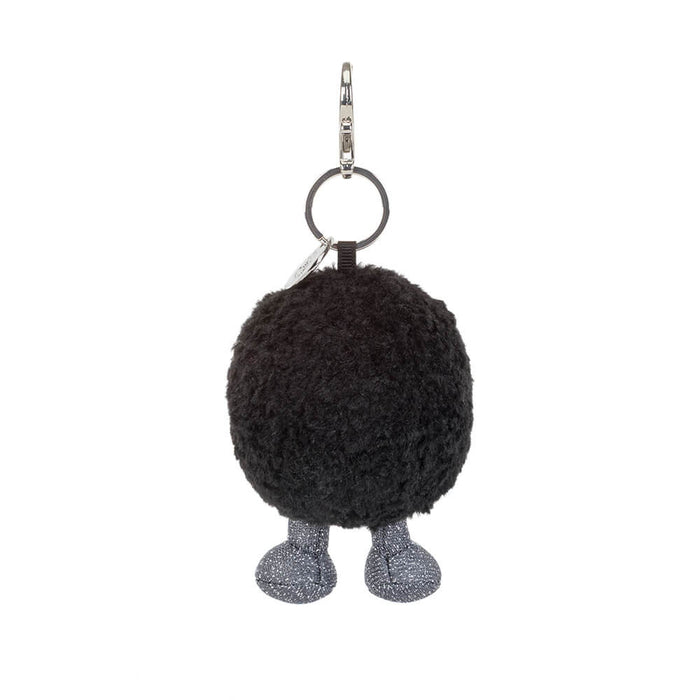 Black hole keychain with legs on a white background
