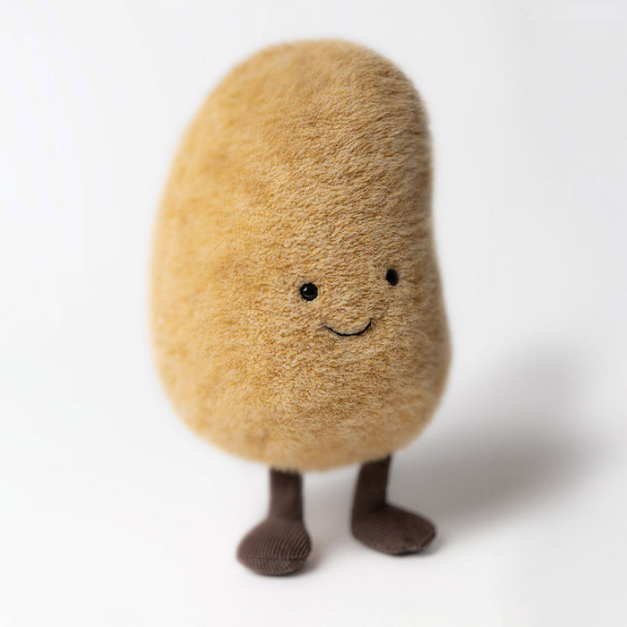 Plush toy resembling a potato with a smiling face on a white background