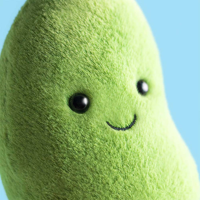 Plush Edamame toy with a smiling face against a blue background
