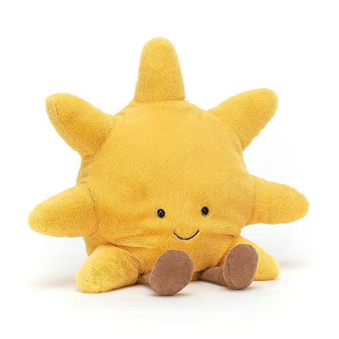 Yellow plush sun toy with a smiling face on a white background