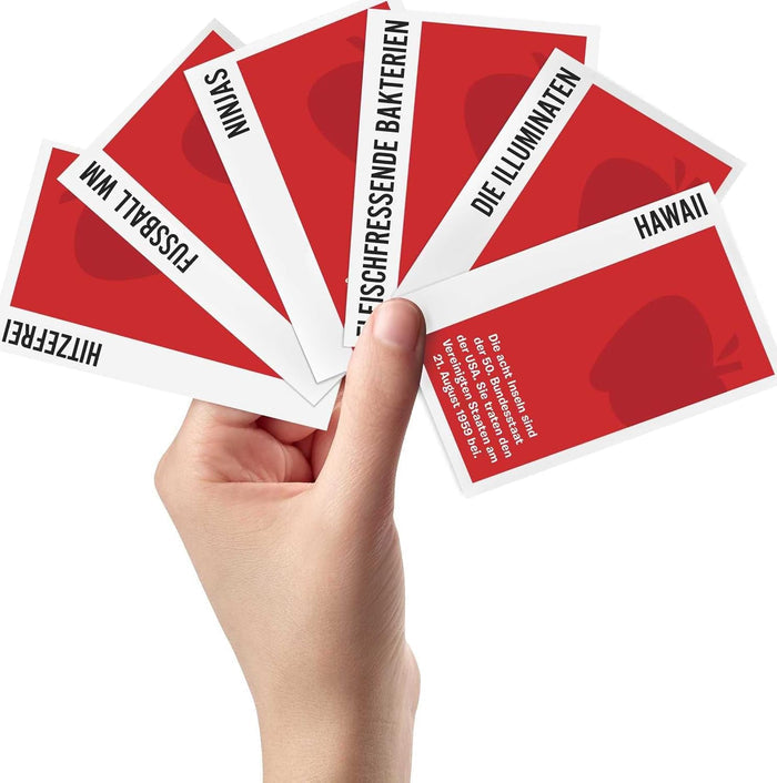 Hand holding red cards with white text on a white background