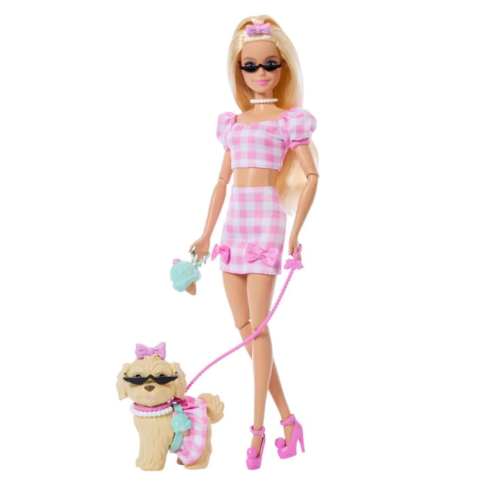 Barbie doll in pink checkered outfit with dog on a white background