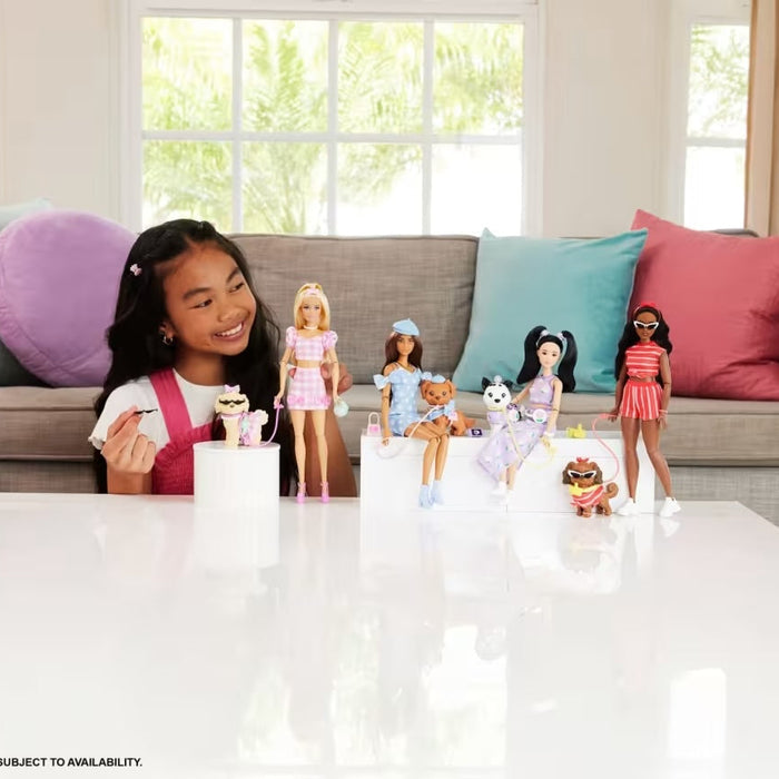 Young girl playing with Barbie dolls in a living room setting