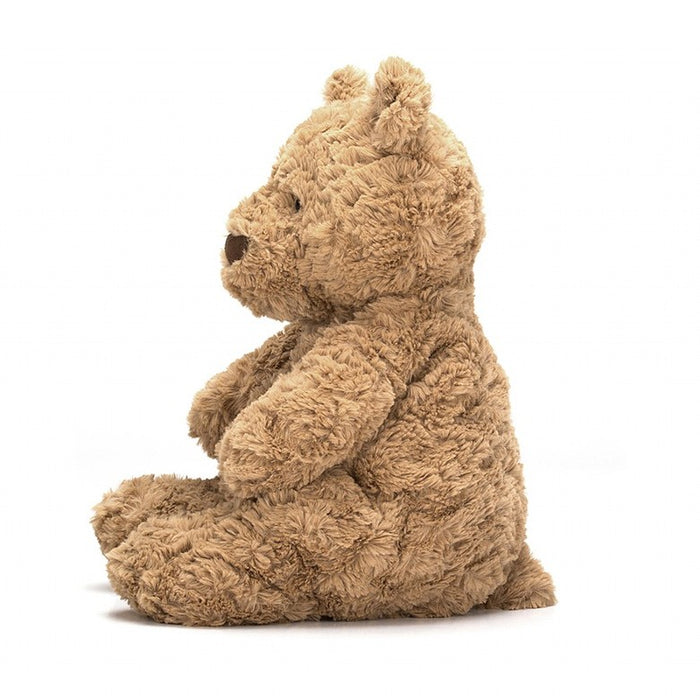 Side view of a plush brown bear on a white background