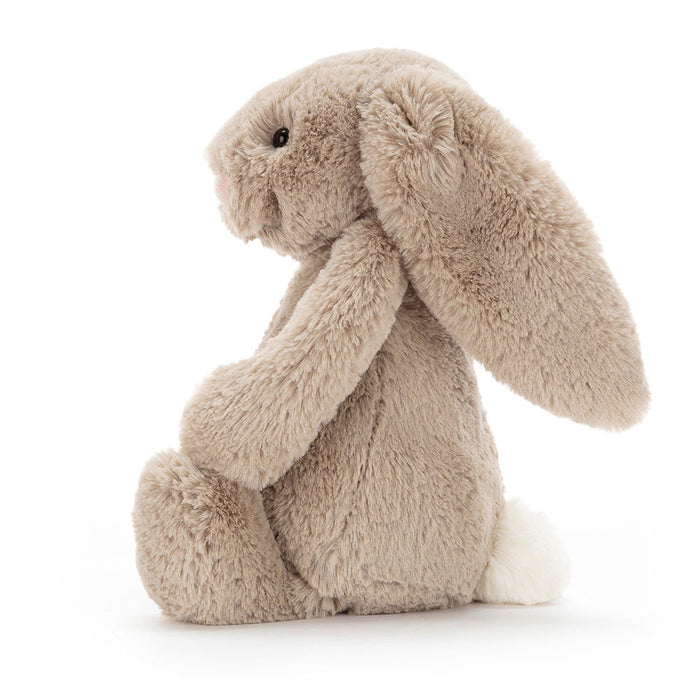 Side view of a plush bunny toy on a white background