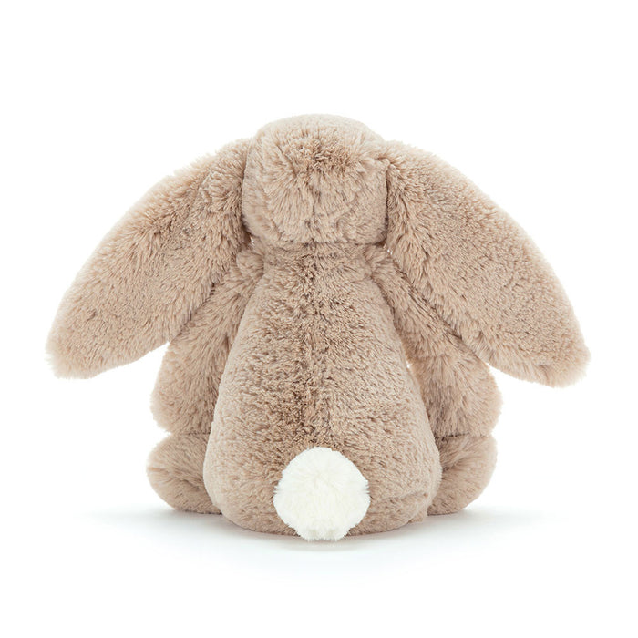 Rear view of a plush bunny toy on a white background