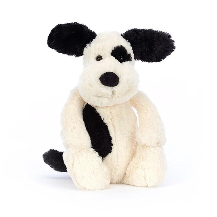 Black and white plush dog toy on a white background