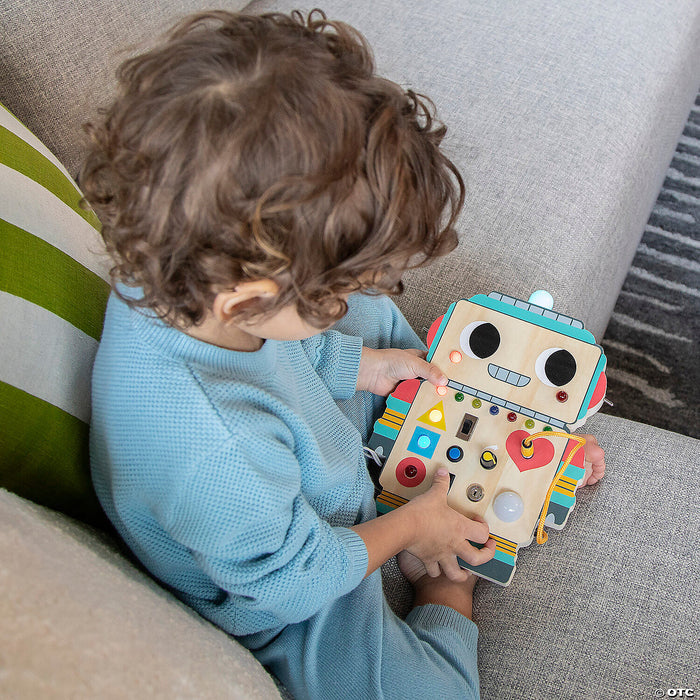 Child playing with Blinkity Bot on a grey sofa.