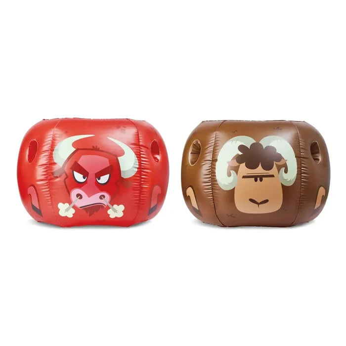 Two inflatable bumper balls, shown side by side on a plain white background. The left ball is red with a bull face and white horns, and the right float is brown with a ram face and cream horns.