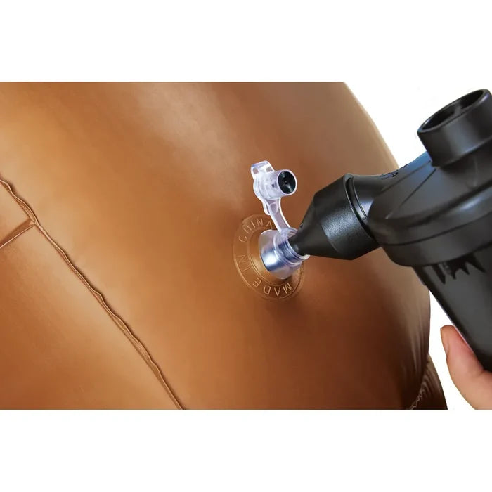 A close-up of an inflatable bumper ball being pumped up with a black manual pump. A hand is visible holding the pump, and the ball has a clear inflation valve with a clear cap.