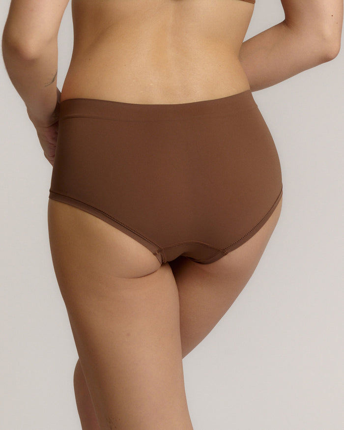 A mid-rise brown brief underwear with a seamless design, showing the waistband and part of the leg openings.
