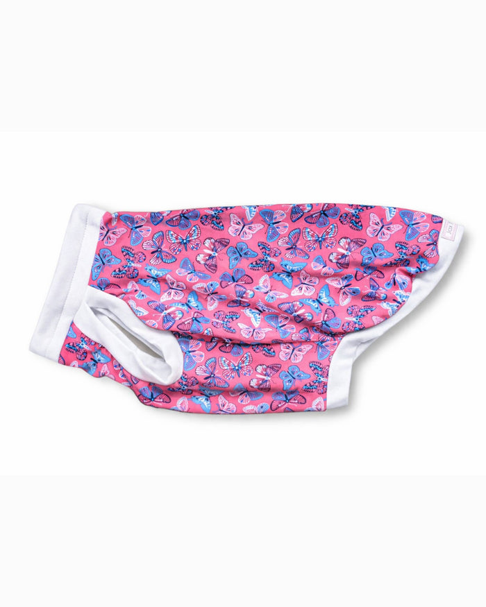 Bubblegum Butterfly cotton-spandex dog pajamas flat lay side view showing leg opening and white trim, Jax & Molly’s