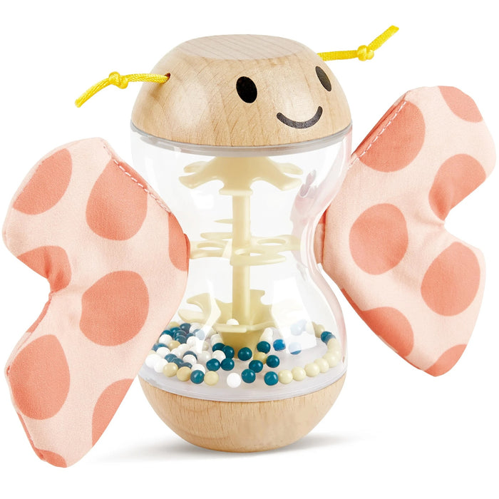Wooden toy with pink polka dot wings on a white background