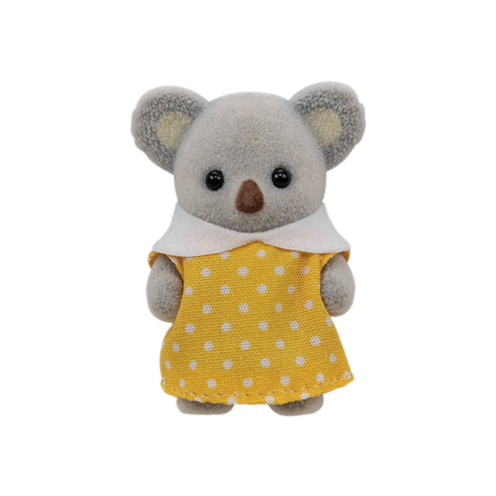 A small plush koala toy wearing a yellow dress with white polka dots and a white collar, centered on a plain white background.