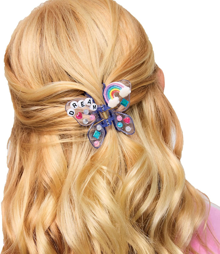Decorated hair clip holding a girls blond hair.