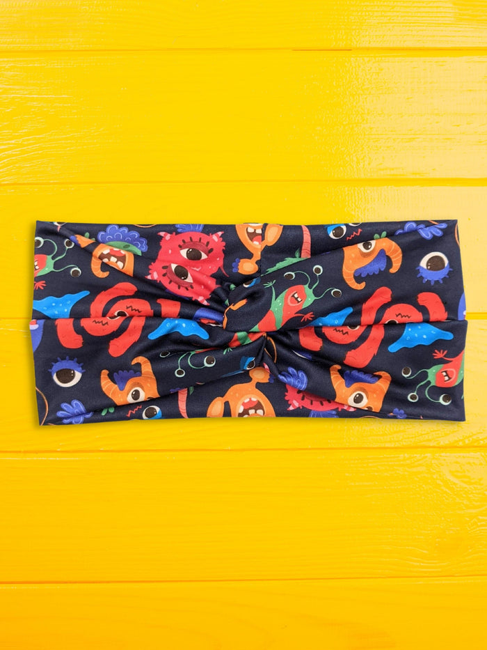 colorful monsters poly spandex knot headband flat lay front view wide band knot detail