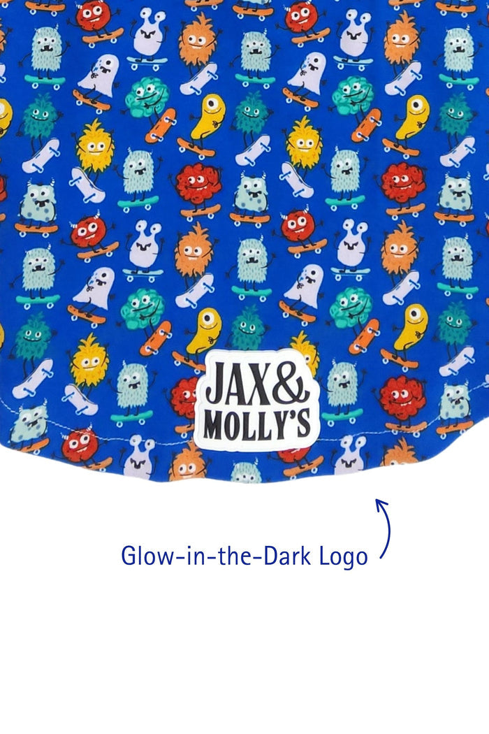 Colorful Skateboarding Monsters cotton spandex lightweight dog hoodie, close-up of glow in the dark Jax & Molly's brand logo