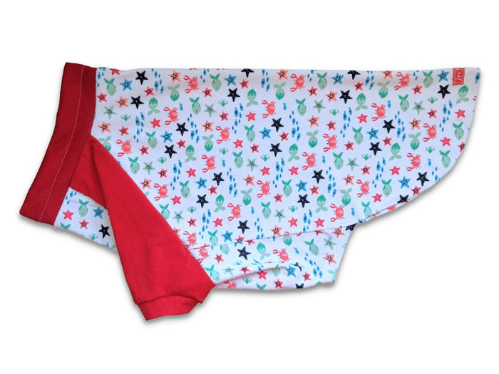 Side profile of Jax & Molly's red and white dog pajamas, decorated with sea creatures and complemented by red sleeves.