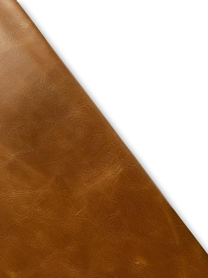 Saddle-style distressed cowhide close view showing grain and texture
