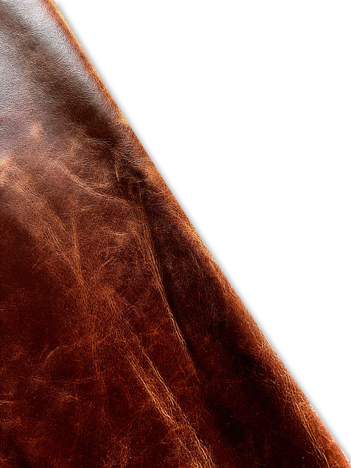 Saddle-style distressed cowhide surface detail showing texture and finish