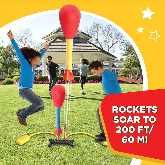 Kids playing on the grass in their backyard with Dueling Stomp Rockets.