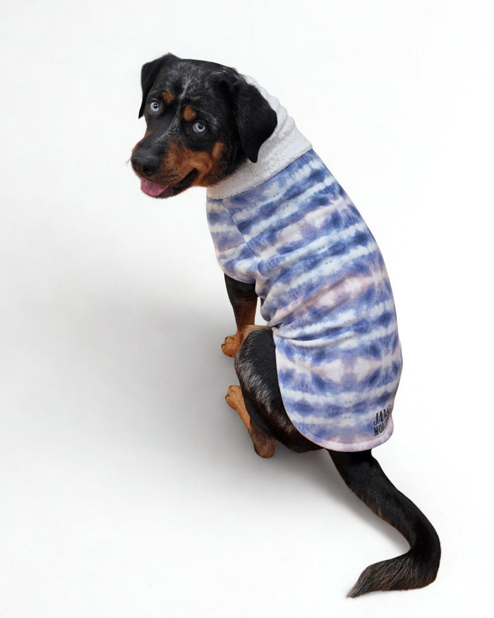 Fantasia purple tie-dye fleece dog sweater with white sherpa turtleneck on black dog, back view sitting