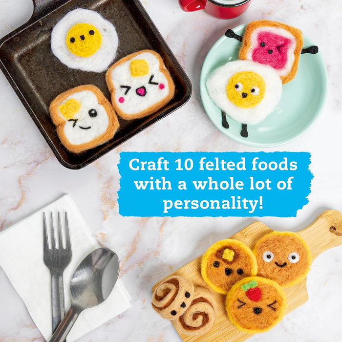 A styled flat-lay of handcrafted felt food items on a white marble surface, including egg-shaped pancakes, toast slices, and a cinnamon roll, with a blue text overlay that reads 'Craft 10 felted foods with a whole lot of personality!'.
