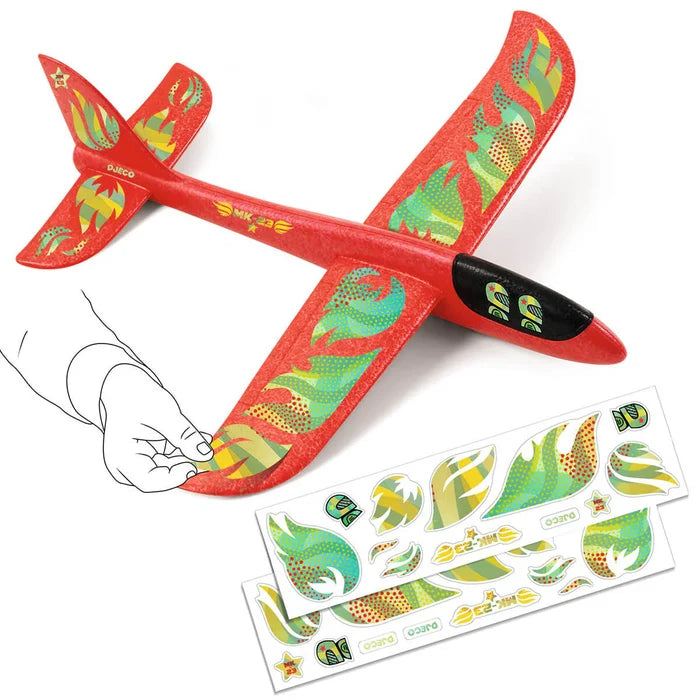 Red toy foam airplane with green and yellow designs on a white background