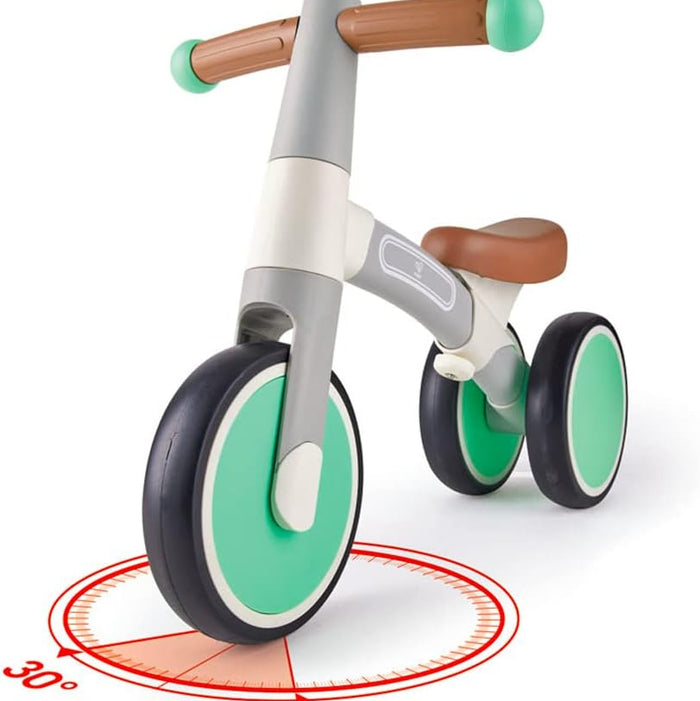 Children's balance bike with green wheels on a white background