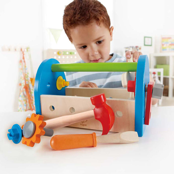 Child playing with the Fix It Tool Box in a bedroom.