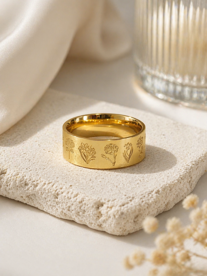 floral engraved gold ring wide band flat lay botanical design neutral background