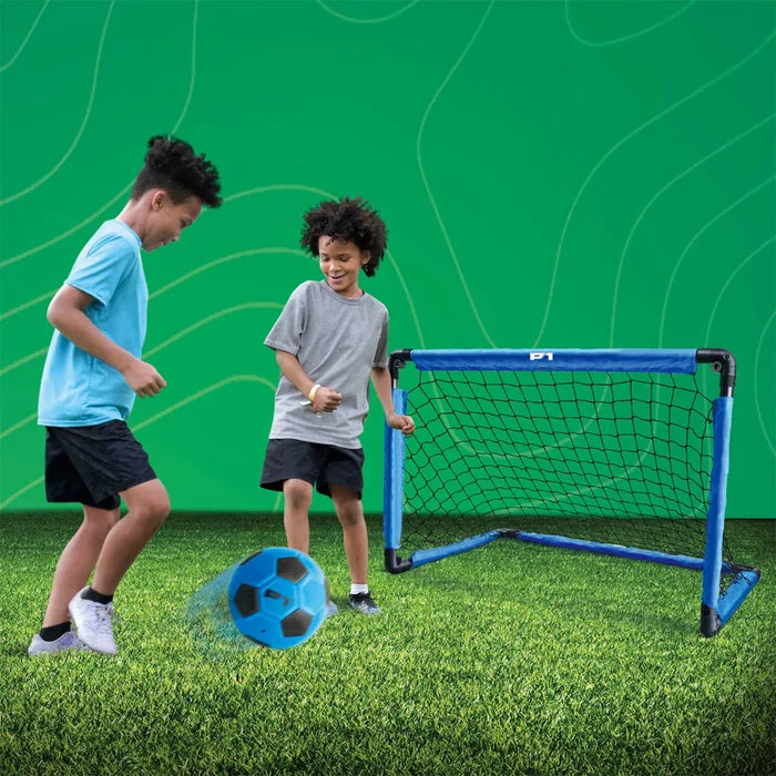Two children playing with a soccer ball and goal on a green field.