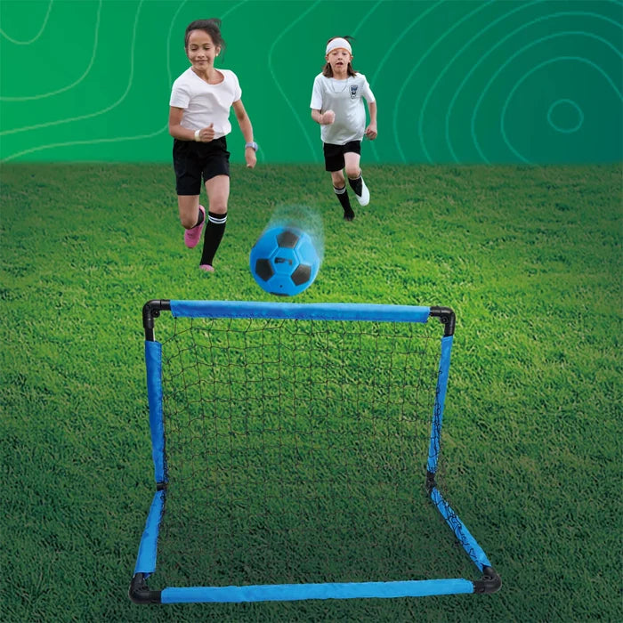 Children playing soccer with a blue goal on a green field