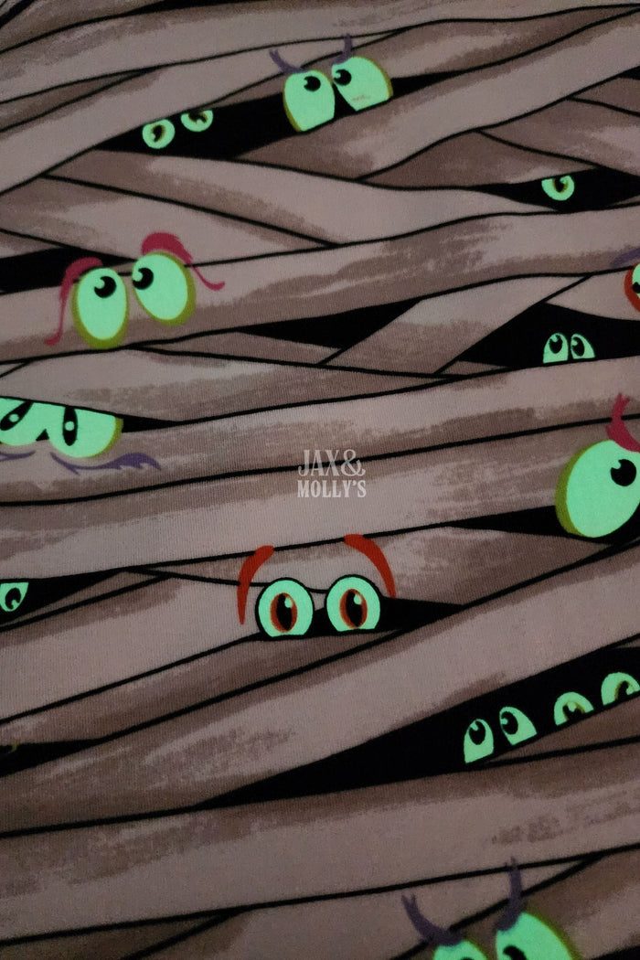 Glow-in-the-dark Fabric with eyes peeking out from behind woven strands
