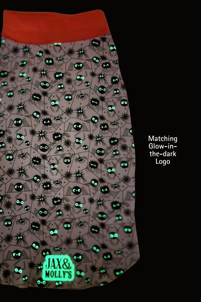 Halloween dog jammies with spider pattern and 'Jax & Mollys' branding, glow-in-the-dark effect.
