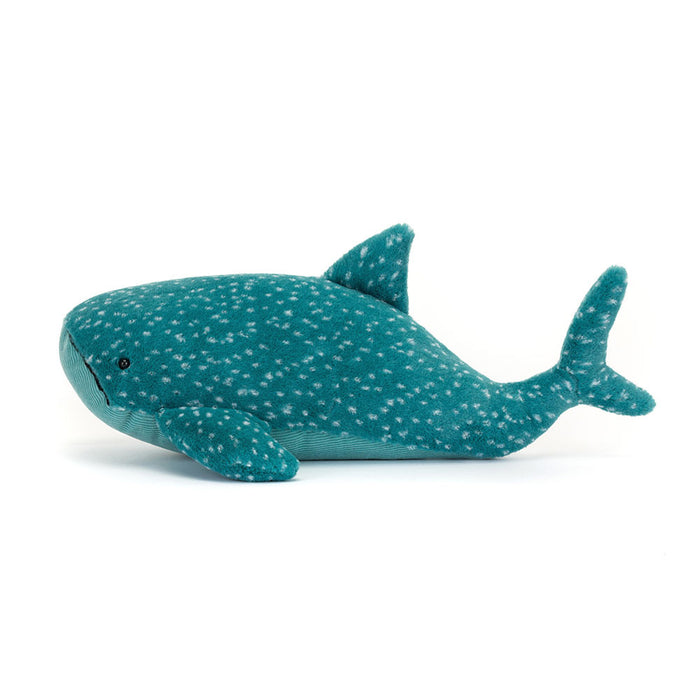 Plush whale toy with white spots on a white background