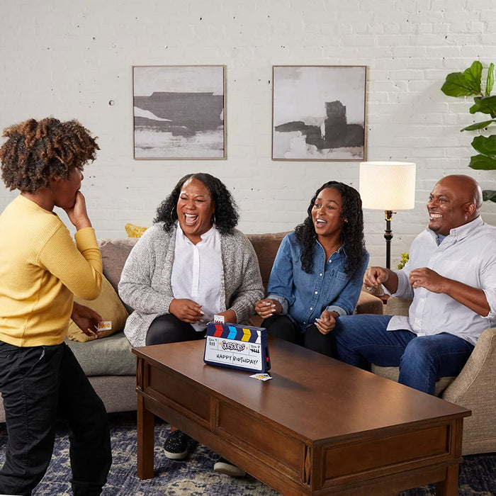 Four people playing Guesstures in a cozy living room