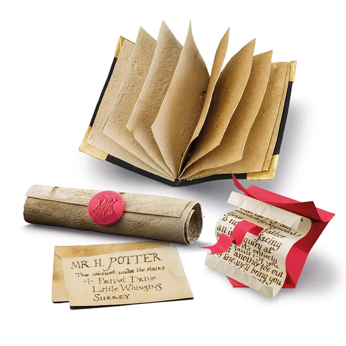 Open book with rolled-up letter, envelope, and address label on a white background