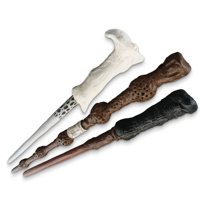 Three decorative wands with different handles on a white background