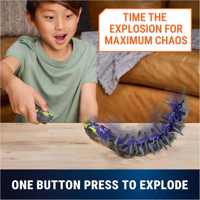 Child playing with Hex Bot Explodapede on a wood table with text 'one button press to explode'