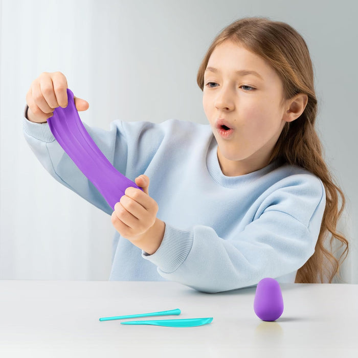 Child playing with a purple Hey clay on a white background